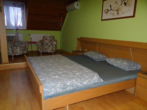 a bedroom with a bed with two pillows on it at Villa La Vita in Hévíz