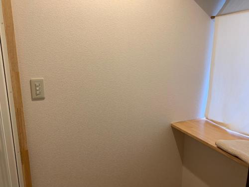 a white door in a room with a window at Guest House YAMASHITA-YA in Nanto