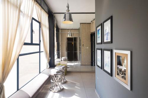 a living room with a couch and a large window at Hillel 11 Hotel in Jerusalem