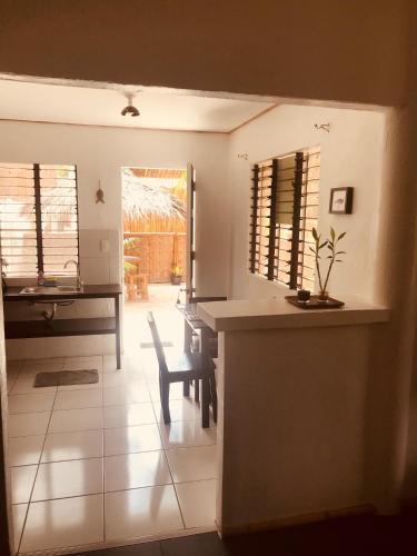 a kitchen and dining room with a table and chairs at Everyday Sunday Hotel & Cafe in Bantayan Island