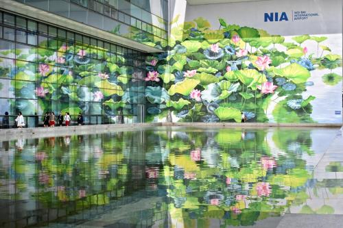 a mural of flowers on the side of a building at New Sky Airport Hotel in Noi Bai