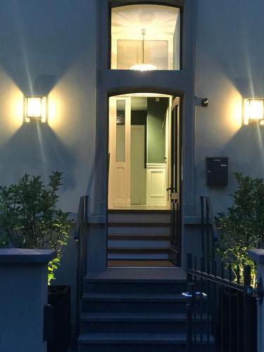 a white door on a house with stairs at Konrads Limburg - Hotel & Gästehaus in Limburg an der Lahn