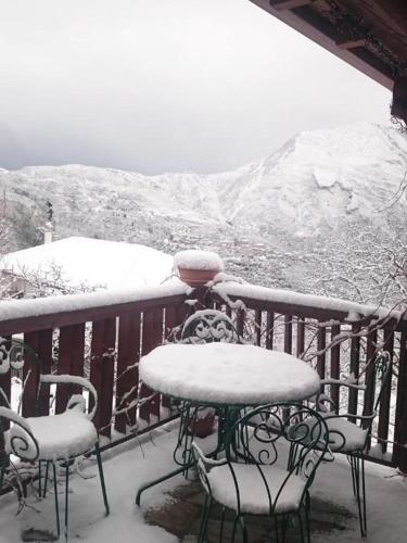 a table and chairs on a balcony covered in snow at Alagonia Country Homes in Alagonía