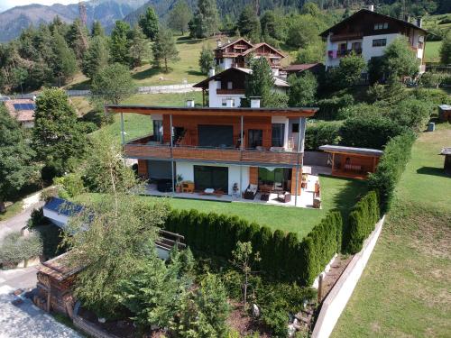 an aerial view of a house in the mountains at Casa de Fiemme in Tesero