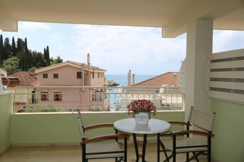 a table and chairs on a balcony with a view at Hotel Maistrali in Parga
