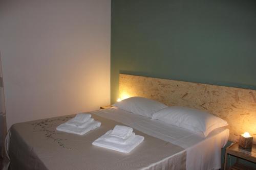 a bedroom with a bed with two towels on it at Casa Madè in Chieti