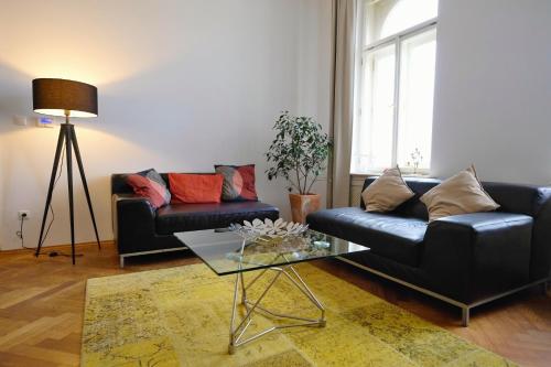 a living room with a couch and a table at Pawlansky Apartments in Prague