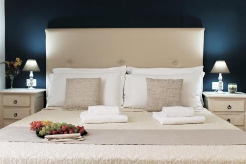 a bed with a white comforter and pillows at AHR Leonis Residence La Maddalena in La Maddalena