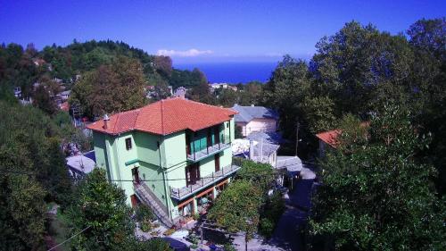 a large house with a red roof on a hill at Sofia Rooms in Kissós