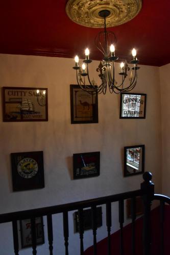 a chandelier on a wall with pictures on it at The Bull Hotel in Horncastle