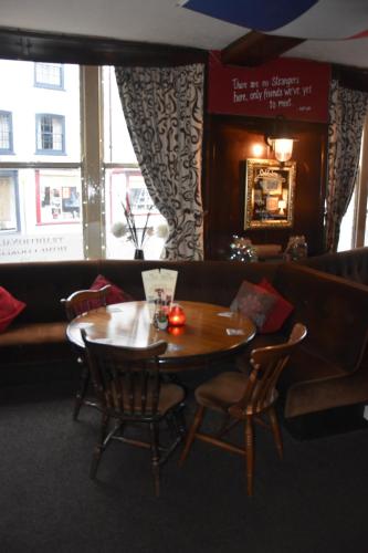 a dining room with a wooden table and chairs at The Bull Hotel in Horncastle