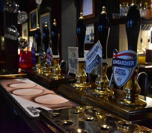 a bar with several bottles of beer on a counter at The Bull Hotel in Horncastle