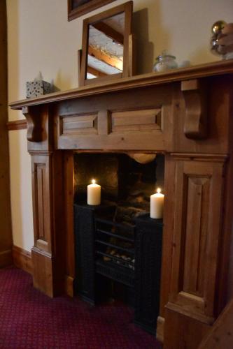 a fireplace with two candles in a room at The Bull Hotel in Horncastle