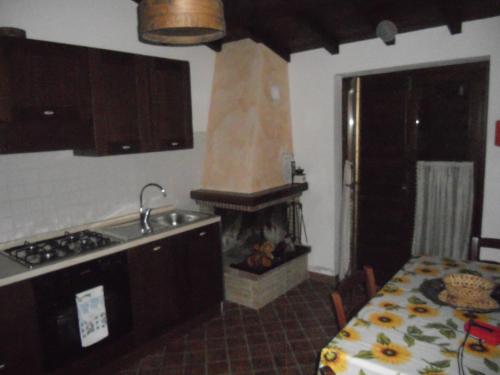 a kitchen with a stove and a fire place at La Fattoria Di Mamma Ro' in Narni