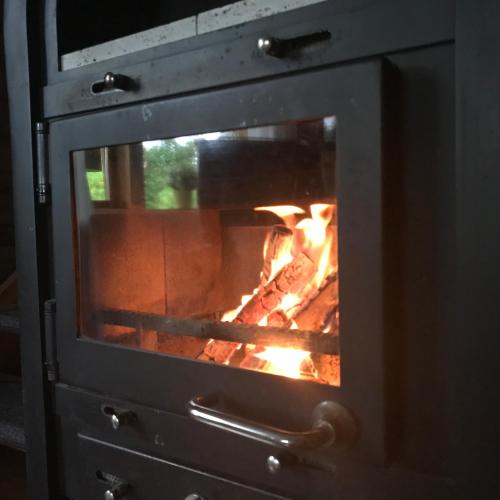 a fire is coming out of an oven at Eifel-Lounge BLOCKHAUS mit Kamin Garten Balkon nahe Köln Therme Brühl Phantasialand in Weilerswist