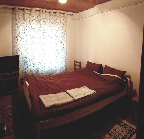a bedroom with a bed with two towels on it at Casa Agricultorului Varzari in Butuceni