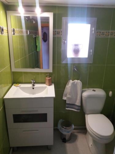 a bathroom with a sink and a toilet and a mirror at Kasa Karmen in Fuenmayor