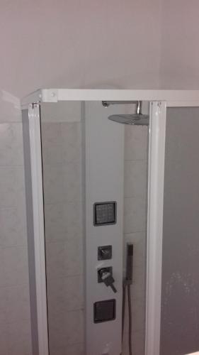 a shower in a bathroom with a mirror at Maria's View in Ios Chora