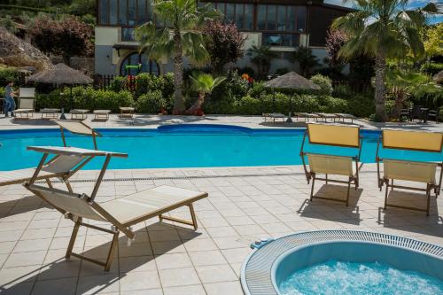 a group of chairs sitting next to a swimming pool at Country House Il Cascinale in Colonnella