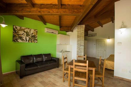 a living room with a couch and a table and chairs at Country House Il Cascinale in Colonnella