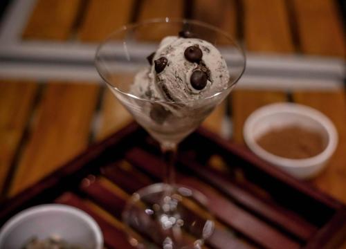 a wine glass with a chocolate ice cream in it at Hotel Imperial in Vasai