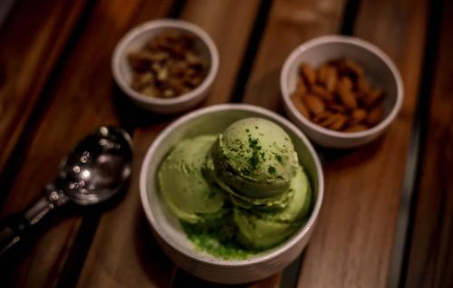 a table with three bowls of green ice cream at Hotel Imperial in Vasai