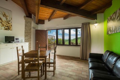 a living room with a table and a couch at Country House Il Cascinale in Colonnella