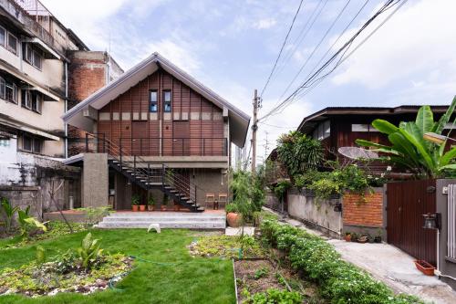 a house with a grass yard in front of it at Baan Boon in Bangkok