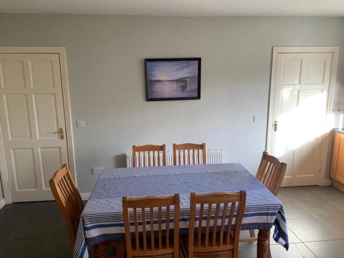 a dining room with a blue table and chairs at Holiday Home Waterville in Waterville