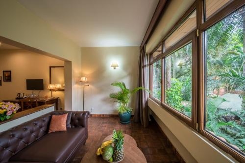 a living room with a couch and a large window at Speke Hotel 1996 Ltd in Kampala