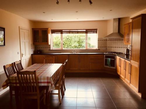 a kitchen with a table and chairs and a window at Holiday Home Waterville in Waterville