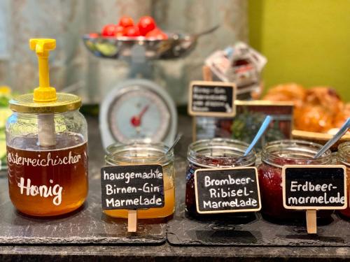 a table with jars of honey and signs on it at Das Franzl - Bett & Brot in St. Wolfgang