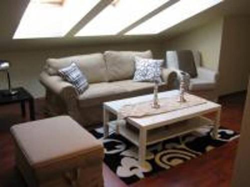 a living room with a couch and a table at Swinoujscie Poland Luxury Penthouse Sleeps 9 in Świnoujście