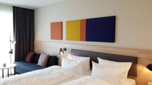 a bedroom with a bed and a blue couch at Die Sandburg in Langeoog