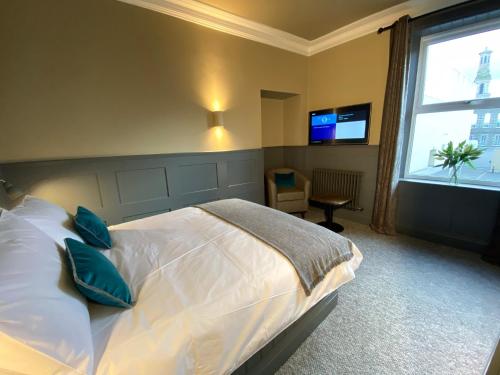 a bedroom with a large bed and a window at Irvine Guest House in Irvine
