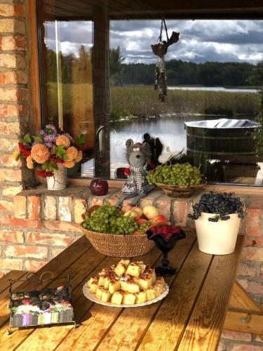 a table with baskets of fruits and vegetables on it at Annes in Pāce