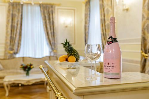 a bottle of champagne and a wine glass on a table at Villa Luttwitz in Baden-Baden