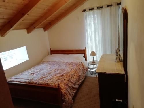 a bedroom with a bed and a window at Tsitalia cottage house in Leonidion