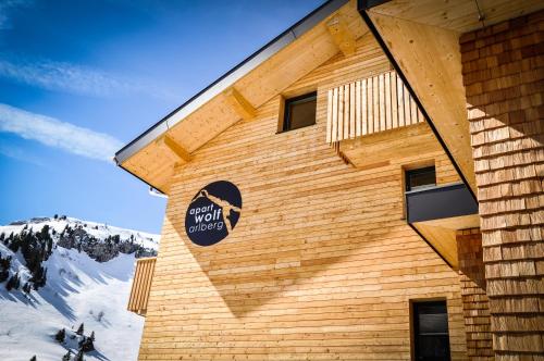 a building with a sign on the side of it at apart-wolf-arlberg in Warth am Arlberg