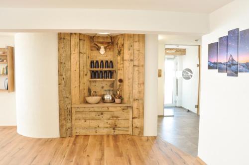 a room with a wooden wall with a wine cellar at apart-wolf-arlberg in Warth am Arlberg