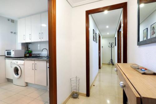 a kitchen with a washer and dryer in a room at Apartamento Centrum Córdoba con Parking in Córdoba
