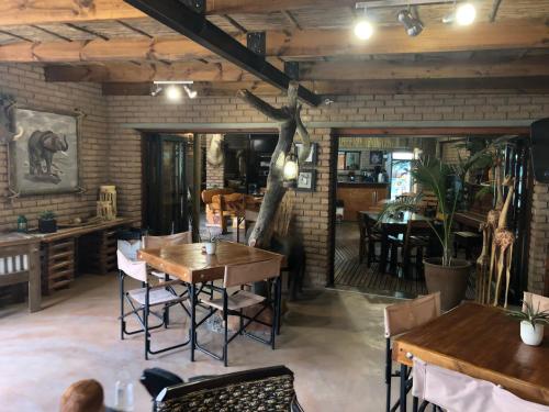a restaurant with wooden tables and chairs in a room at Country Lodge in Upington