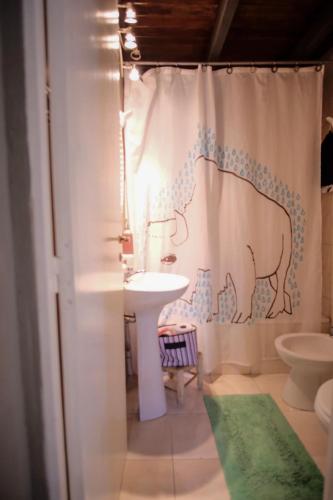 a bathroom with a shower curtain with a cow on it at Leónidas Design Loft in Mendoza