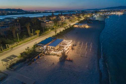 an aerial view of a beach at night at Le Palmette Suites in Cagliari
