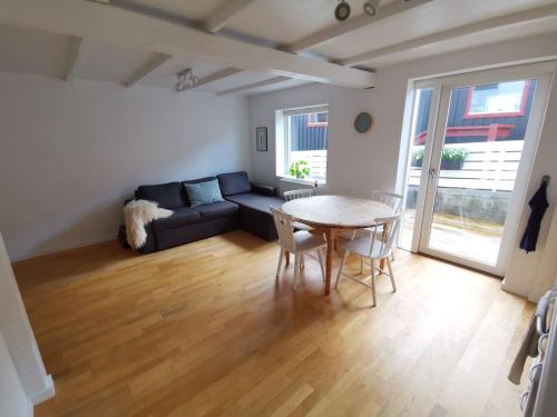 a living room with a table and a couch at City Center Apartment in Tórshavn