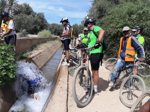 a group of people on bikes on a bridge at Gite Tamlli in Aoufous