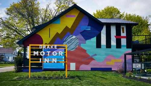 a colorful building with a sign in front of it at Drake Motor Inn in Wellington