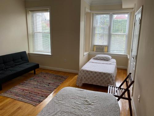 a living room with two beds and a couch at Bloomingdale Beauty near Union Station in Washington