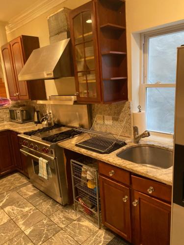 a kitchen with a stainless steel stove and a sink at Bloomingdale Beauty near Union Station in Washington
