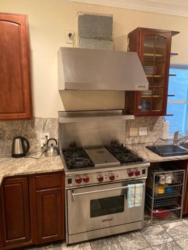 a kitchen with a stainless steel stove with a hood at Bloomingdale Beauty near Union Station in Washington, D.C.